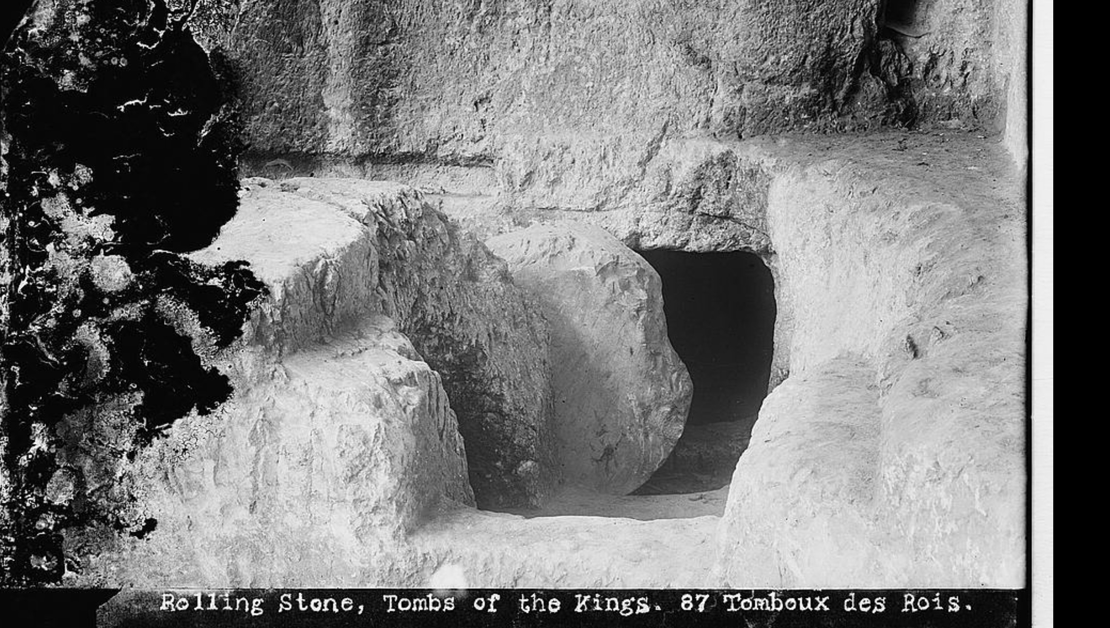 A rock-cut, Second Temple-period tomb near Jerusalem with its rolling stone still in place before the entrance — the kind of tomb the Gospels describe being sealed, and found open. Photographed circa 1900-1920.
